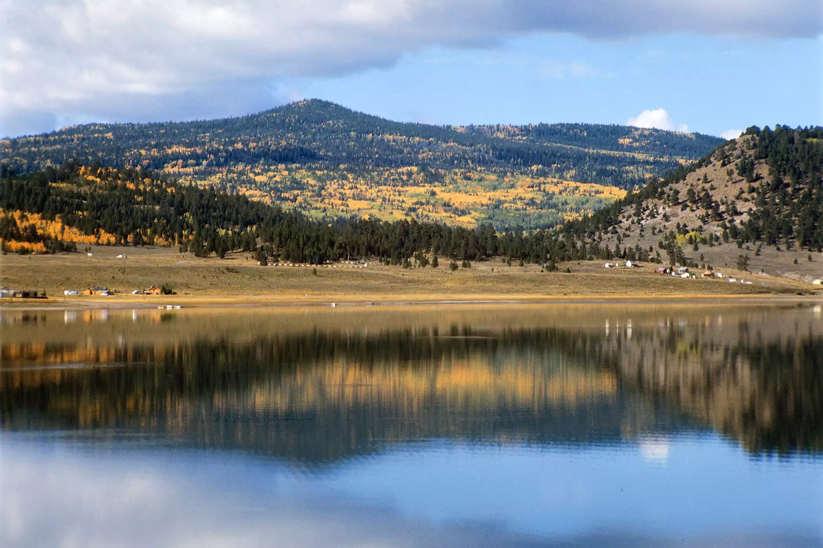 Panguitch Lake in autumn with aspen covered hills reflected in still water